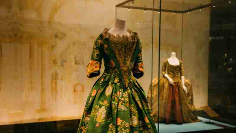 Explore elegant vintage gowns showcased elegantly in a museum exhibit., tags: di - pexel